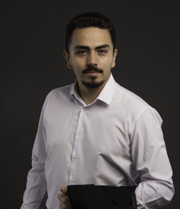 A businessman in dress code holding a black jacket in his arm. High quality photo